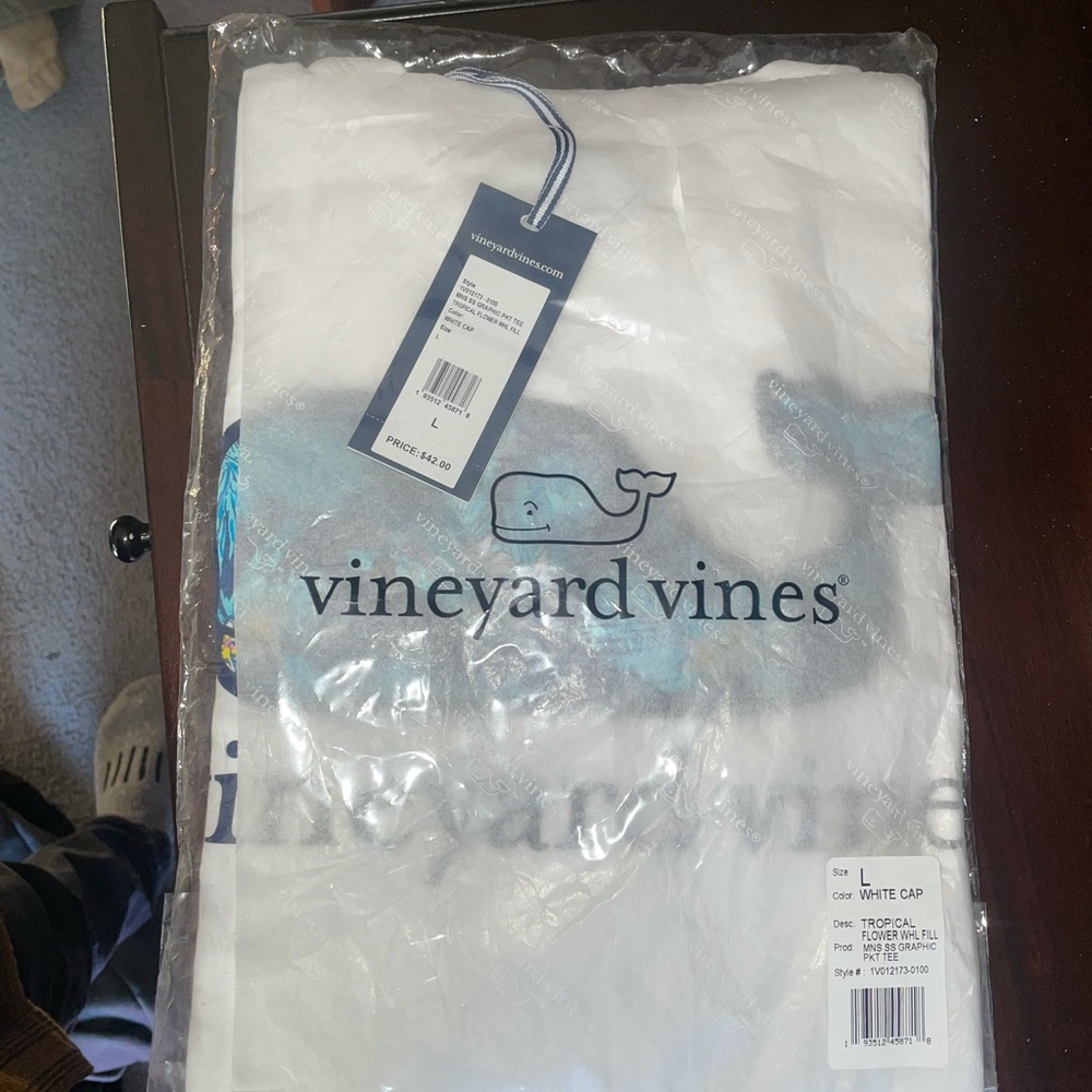 L Vineyard Vines shirt never worn. Received an extra shirt and don't need it.